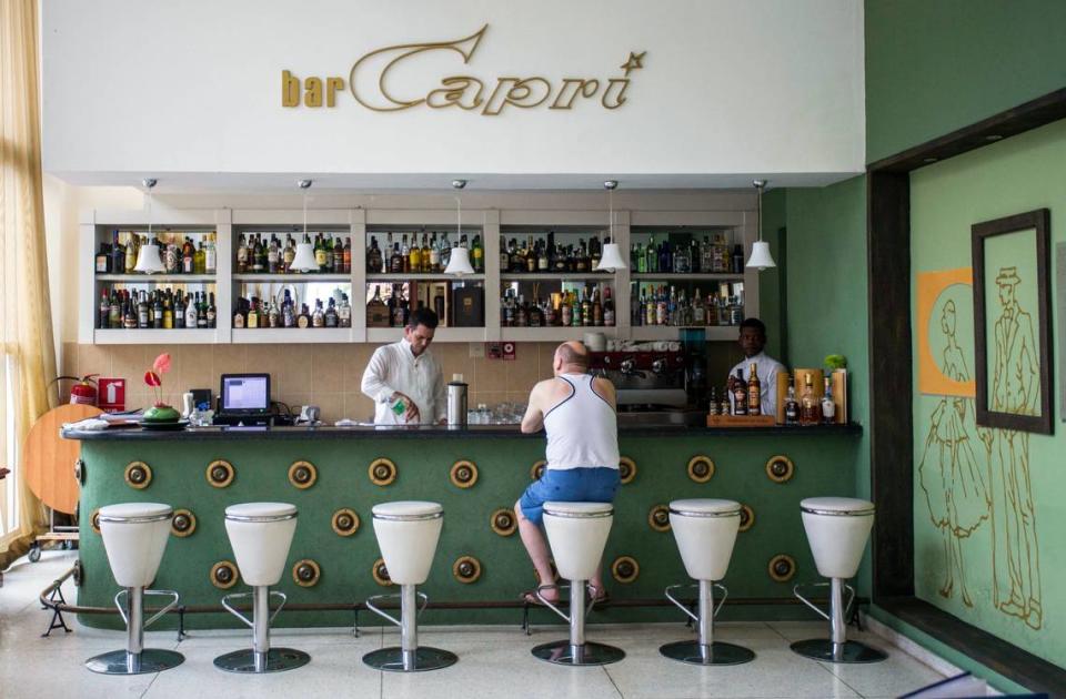 In this Sept. 12, 2017, file photo, a customer sits at the lobby bar of the Hotel Capri in Havana, Cuba, where an American official reported being the victim of what was later labeled Havana Syndrome.