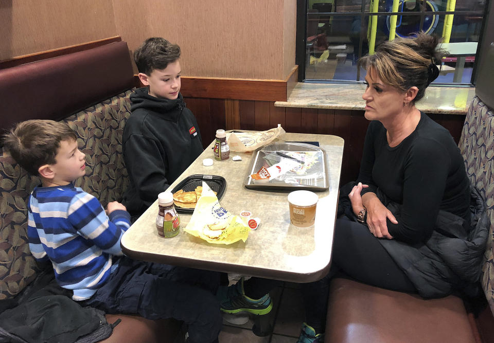 In this Jan. 10, 2019, photo, Tamra Cartwright, right, talks with sons Connor, 7, left, and Caden, 11, about the effect of multiple aftershocks from Alaska's recent magnitude 7.0 earthquake while interviewed in Anchorage, Alaska. Connor Cartwright says the aftershocks terrify him, and he fears his Anchorage home won't hold up. (AP Photo/Rachel D'Oro)