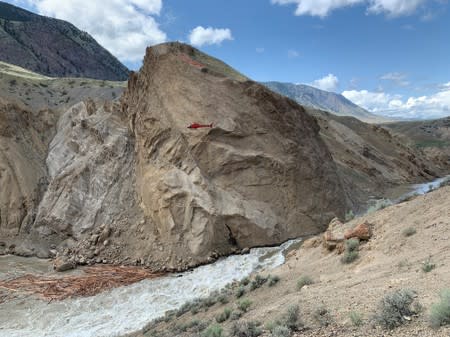 A helicopter flies past the site of the Big Bar landslide on the Fraser River northwest of Clinton