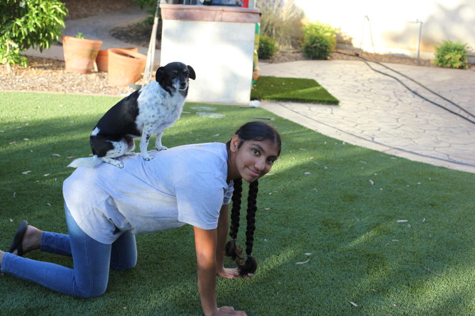 Meena Kumar's dog, Bambie, stands on her back. (Photo courtesy of Jayashree Subrahmonia)