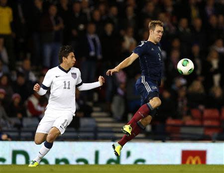 Scotland's Steven Whittaker (R) is challenged by Alejandro Bedoya of the U.S. during their international friendly soccer match at Hampden Park Stadium in Glasgow, Scotland, November 15, 2013. REUTERS/Russell Cheyne