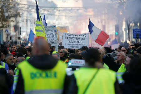 Protesters wearing yellow vests take part in a demonstration of the "yellow vests" movement in Marseille, France, December 15, 2018. REUTERS/Jean-Paul Pelissier