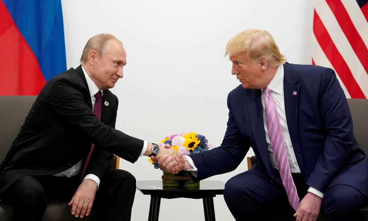 <span>Vladimir Putin and Donald Trump shake hands during a bilateral meeting at the G20 leaders summit in Osaka, Japan, on 28 June 2019. </span><span>Photograph: Kevin Lamarque/Reuters</span>