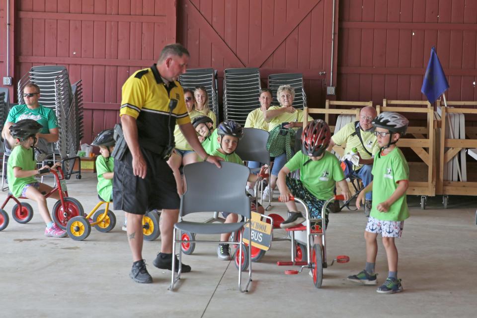 Sandusky County Sheriff Deputy John Johannsen gives instruction in bicycle safety at the 2023 Eagle Bay "Weird Science" Day Camp, at White Star Park in Gibsonburg.