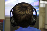 In this Saturday, Oct. 6, 2018, photo Henry Hailey, 10, plays one of the online Fortnite game in the early morning hours in the basement of his Chicago home. His parents are on a quest to limit screen time for him and his brother. The boys say they understand sometimes, but also complain that they get less screen time than their friends. (AP Photo/Martha Irvine)