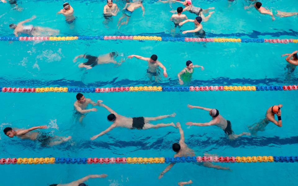 North Koreans swim in a pool in the Munsu Water Park on a national holiday as part of celebrations of the 'Day of the Sun',