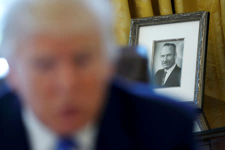 A photo of President Trump's late father Fred Trump sits behind him as he gives an interview with Reuters in the Oval Office. REUTERS/Jonathan Ernst