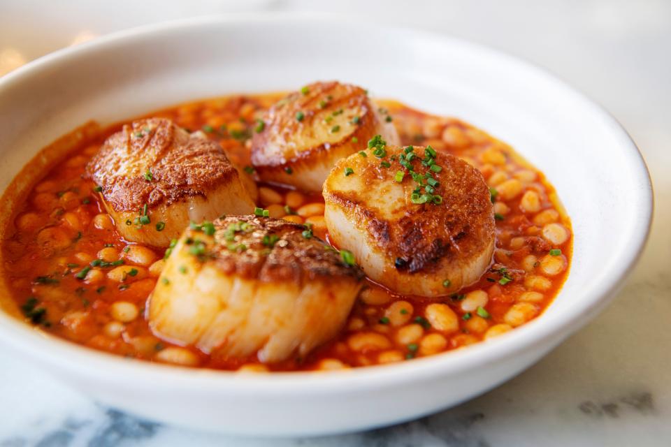 La Bodega’s pescado del dia, scallops with Rancho Gordo white beans, housemate sobrasada and piquillo confit puree.