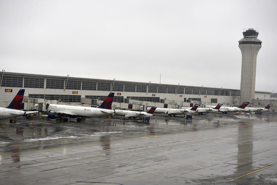 Planes are grounded at Detroit Metro Airport in Romulus, Mich., Wednesday, Jan. 23, 2019, which was closed for hours. Detroit's main airport has reopened after icy weather prompted officials to shut down flights for about 14 hours amid freezing rain. (Clarence Tabb/Detroit News via AP)