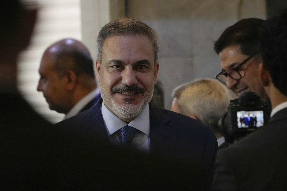 Turkish Foreign Affairs Minister Hakan Fidan, center, arrives at the foreign ministry in Baghdad, Iraq, Thursday, March 14, 2024. (AP Photo/Hadi Mizban)