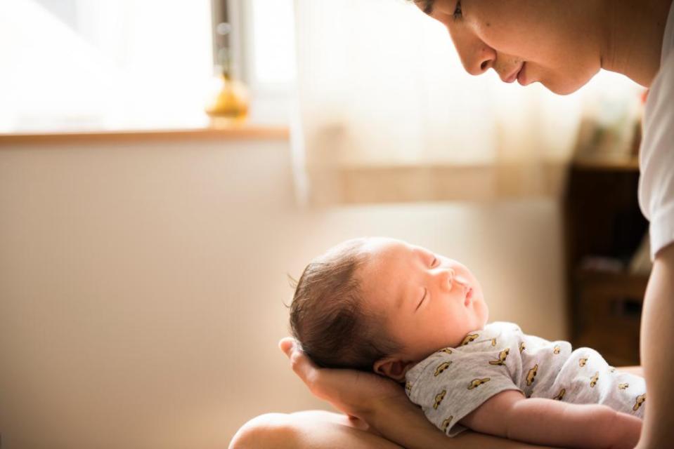 A Japanese man holds his baby.