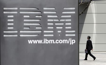 A man walks past the headquarters of IBM Japan in Tokyo March 18, 2010. REUTERS/Toru Hanai