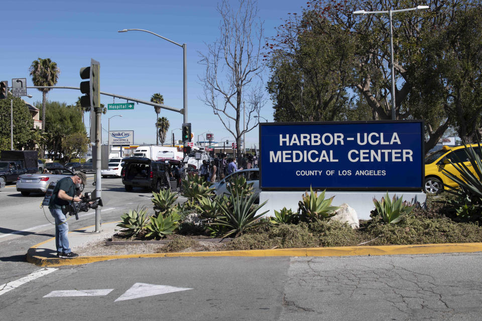 Members of the media gather outside an entrance to Harbor-UCLA Medical Center, Tuesday, Feb. 23, 2021, in Torrance, Calif., where golfer Tiger Woods was hospitalized there following a car accident. (AP Photo/Kyusung Gong)