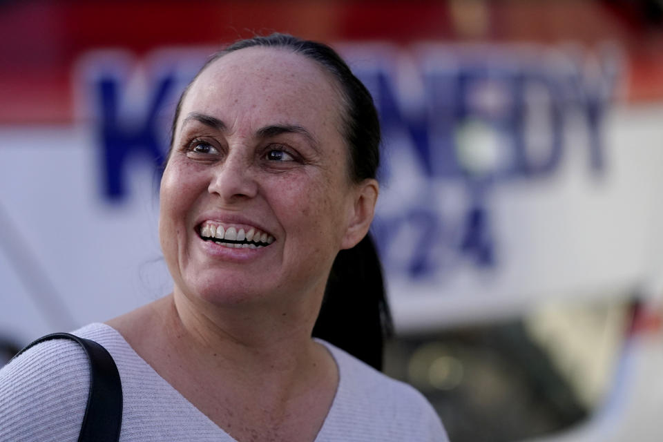 Enriqueta Porras waits in line to enter a voter rally for Independent presidential candidate Robert F. Kennedy Jr., Wednesday, Dec. 20, 2023, in Phoenix. (AP Photo/Matt York)