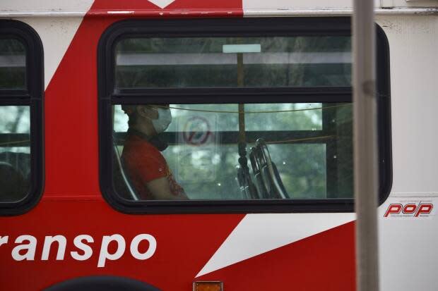 Masks will continue to be required aboard transit and in other enclosed public spaces until at least Aug. 26, Ottawa city council decided Wednesday. (Andrew Lee/CBC - image credit)