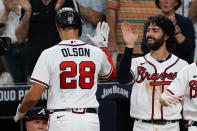 Atlanta Braves' Matt Olson (28) is greeted at the dugout by Dansby Swanson, right, after hitting a two-run home run during the fourth inning of the team's baseball game against the New York Mets on Tuesday, Aug. 16, 2022, in Atlanta. (AP Photo/John Bazemore)