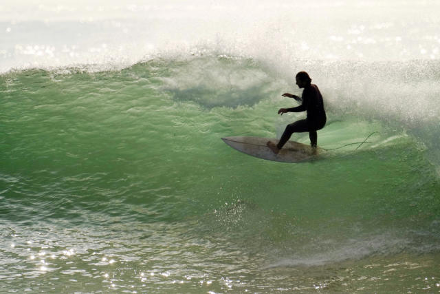 Huge surf pounds beaches on West Coast and in Hawaii with some low