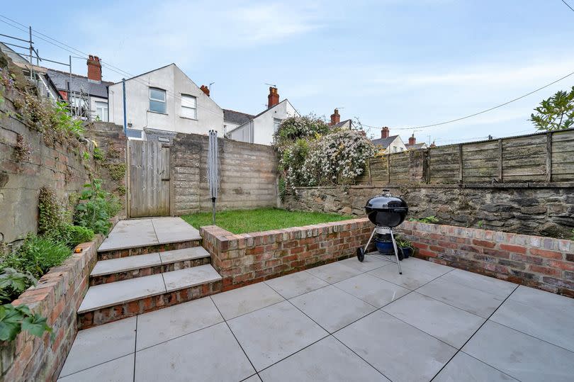 AFTER: The simple but effective design makes it a social space - a house hugging patio and steps to a small lawn