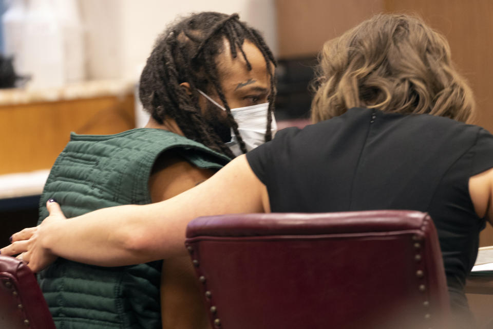 Darrell Brooks, left, speaks with a lawyer during his initial appearance, Tuesday, Nov. 23, 2021 in Waukesha County Court in Waukesha, Wis. Prosecutors in Wisconsin have charged Brooks with intentional homicide in the deaths of at least five people who were killed when an SUV was driven into a Christmas parade. (Mark Hoffman/Milwaukee Journal-Sentinel via AP, Pool)