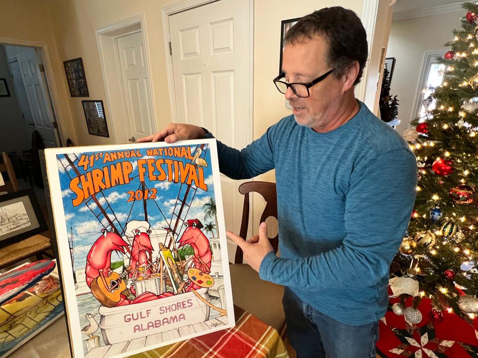 Keith White displays the National Shrimp Festival poster he created in 2012. The poster won that year and earned him an invitation to compete in this year's contest, which was open only to previous contest winners. White also won this year's contest.