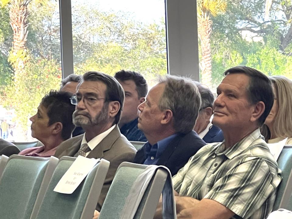 Real estate developer Carl Velie, right, listens to testimonies at an Ormond Beach City Commission meeting Tuesday night, April 16, 2024. The commission voted unanimously to reject a request by Velie and his partners for a zoning map amendment to designate the former Sam Snead golf course at Tomoka Oaks as "Residential-2." The developers want to convert the course into a new gated community called Tomoka Reserve.