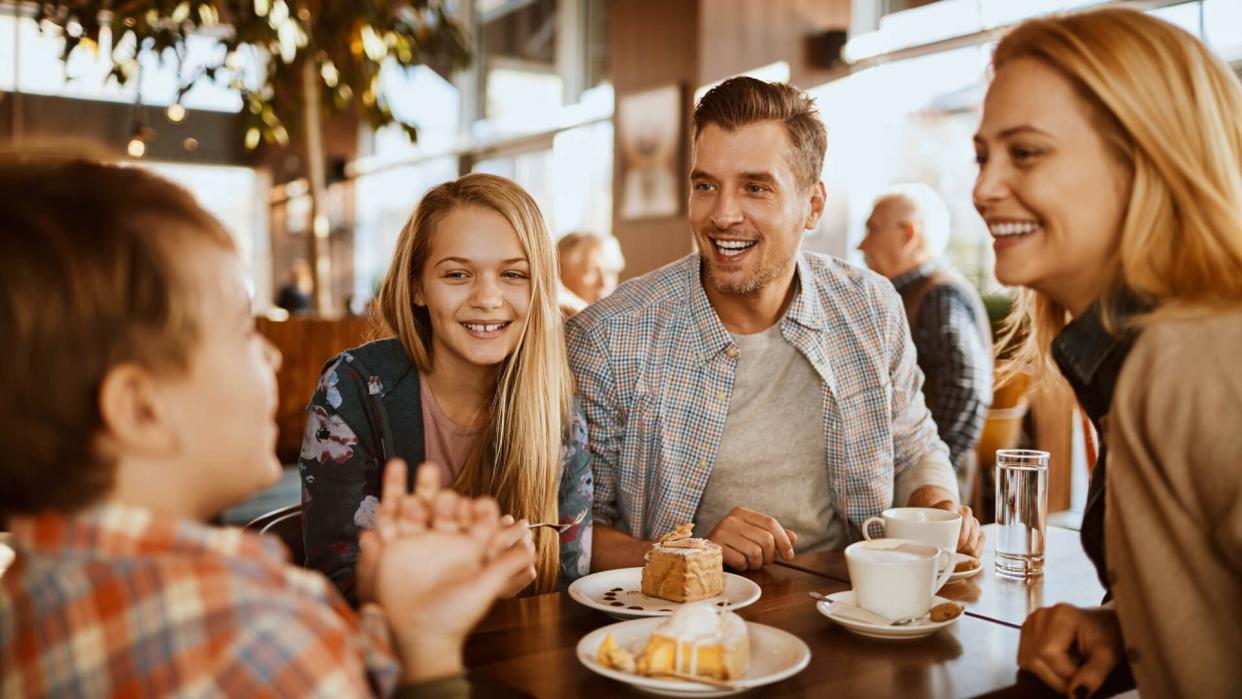 Close up of a young family spending time in a cafe.