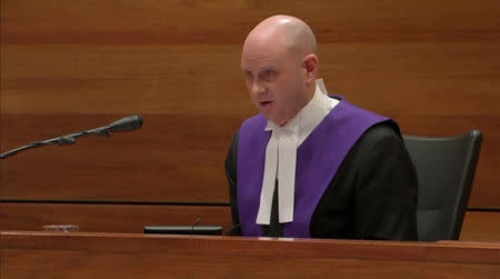 Chief judge Peter Kidd delivers the sentence of former Vatican treasurer Cardinal George Pell, following PellÕs conviction for sexually abusing two choir boys, in Melbourne, Australia, March 13, 2019, in this still image taken from video. AUSTRALIAN BROADCASTING CORPORATION/via REUTERS TV