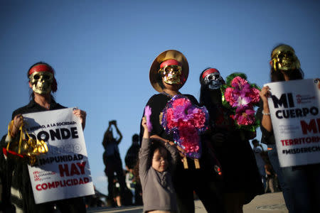 Activists take part in a march to protest violence against women and the murder of a 16-year-old girl in a coastal town of Argentina last week, at Revolucion monument, in Mexico City, Mexico, October 19, 2016. REUTERS/Edgard Garrido