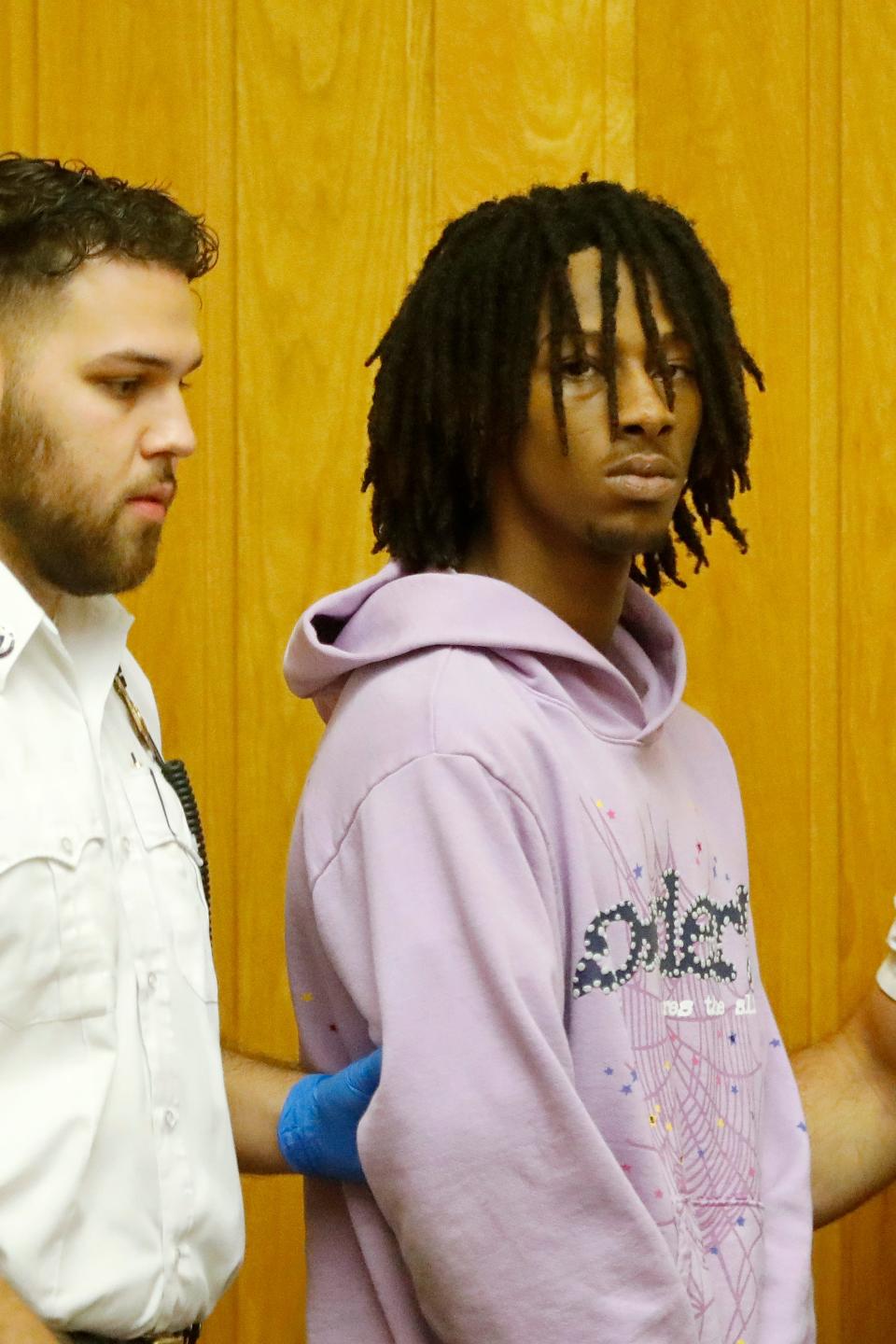 Cheybane Vasconcelos-Furtado, 20, is brought into the New Bedford Third District Court courtroom where he was arraigned for a number of charges including Armed Assault with Intent to Murder in connection with an undercover New Bedford police officer who was shot in the face last week.