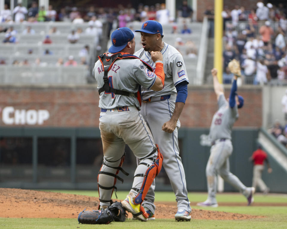 Francisco Alvarez and Edwin Díaz celebrate after winning the opener. (Edward M. Pio Roda/Getty Images)