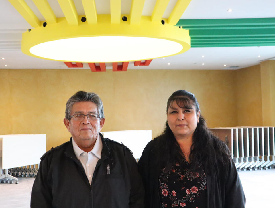 On, Jan. 16, 2023, Pueblo of Zia Governor Valentino Pino and Marsha Leno, Zia Pueblo’s education director, stand in the Pueblo’s early education center, which is under construction. Above them is the Zia sun symbol which has a sacred meaning to the people of Zia Pueblo, who have long fought against its appropriation. (Bella Davis / New Mexico In Depth)