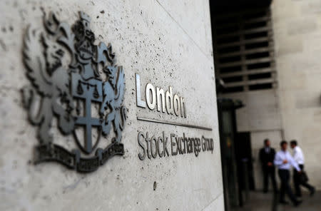 Pedestrians leave and enter the London Stock Exchange in London, Britain August 15, 2017. REUTERS/Neil Hall