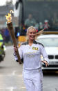 Laura Whitmore carries the Olympic Flame on the Torch Relay leg between St Ives and Huntingdon.
