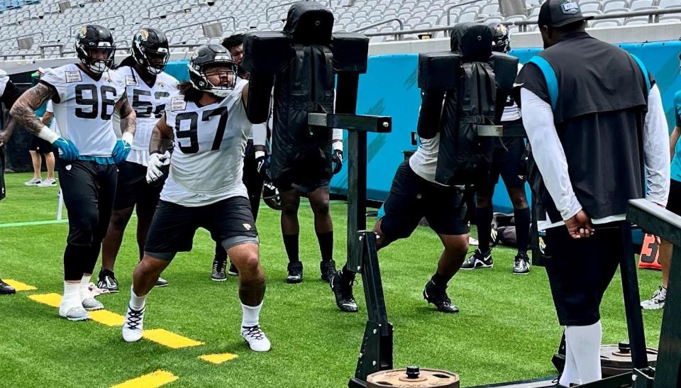 Jaguars defensive tackle Jay Tufele (97) hits a blocking sled during training camp on Tuesday at TIAA Bank Field.