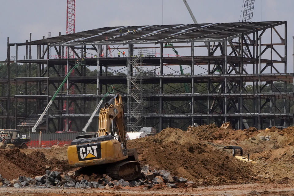 Construction personnel work on Carolina Panthers' state-of-the-art team headquarters and practice facility Tuesday, Aug. 24, 2021, in Rock Hill, S.C. "The Rock" will host all of the team's offices and training/locker room facilities, along with three outdoor grass practice fields, one indoor artificial field and another outdoor artificial field that is part of a 5,000-seat multipurpose stadium that can also be used to host high school football and soccer games, concerts, car shows and much more. (AP Photo/Chris Carlson)