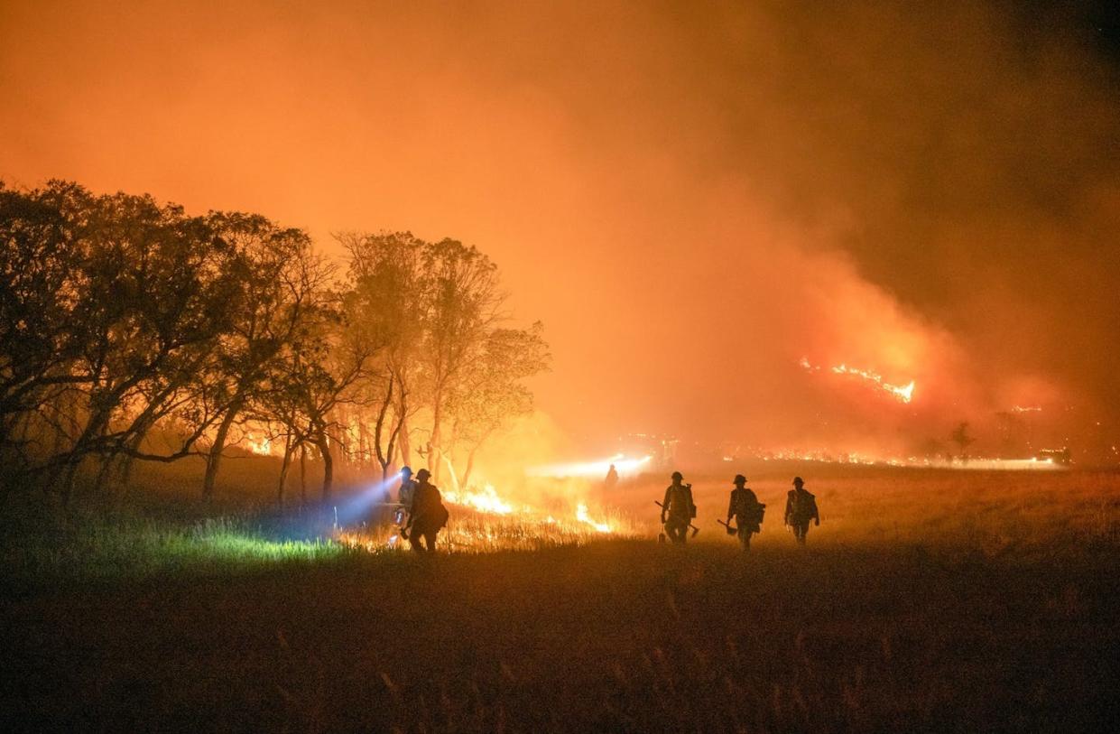 A Wyoming Hotshot crew conducts night operations on the Pine Gulch fire in Colorado in August 2020. <a href="https://www.flickr.com/photos/nifc/50321123752" rel="nofollow noopener" target="_blank" data-ylk="slk:Kyle Miller, Wyoming Hotshots, USFS;elm:context_link;itc:0;sec:content-canvas" class="link ">Kyle Miller, Wyoming Hotshots, USFS</a>