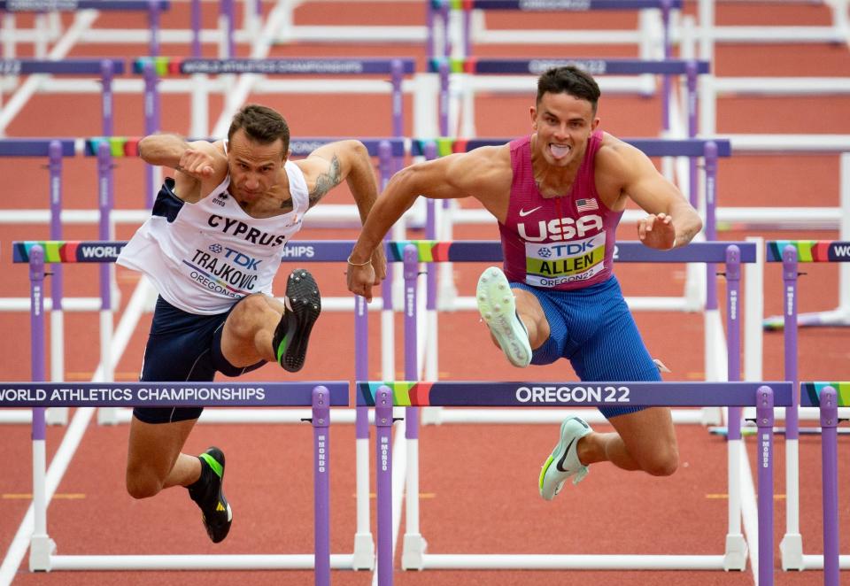 Devon Allen, right, struggles, but still manages to win his heat of the men's 110 hurdles during day two of the World Athletics Championships at Hayward Field in Eugene, Oregon July 16, 2022.
