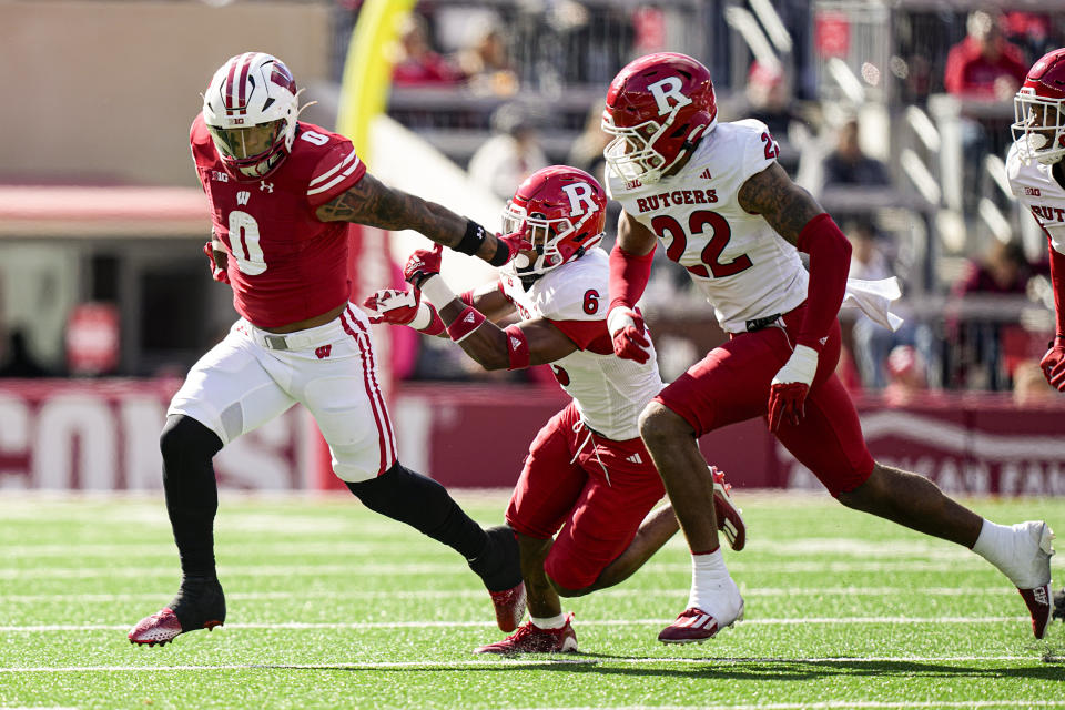 Wisconsin running back Braelon Allen (0) carries the ball ahead of Rutgers defensive back Shaquan Loyal (6) and linebacker Tyreem Powell (22) during the first half of an NCAA college football game Saturday, Oct. 7, 2023, in Madison, Wis. (AP Photo/Andy Manis)