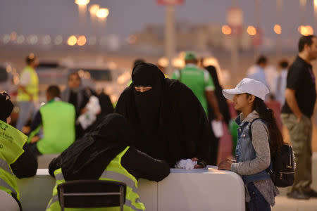 A Saudi woman arrives to watch the soccer match between Al-Ahli against Al-Batin at the King Abdullah Sports City in Jeddah, Saudi Arabia January 12, 2018. REUTERS/Reem Baeshen