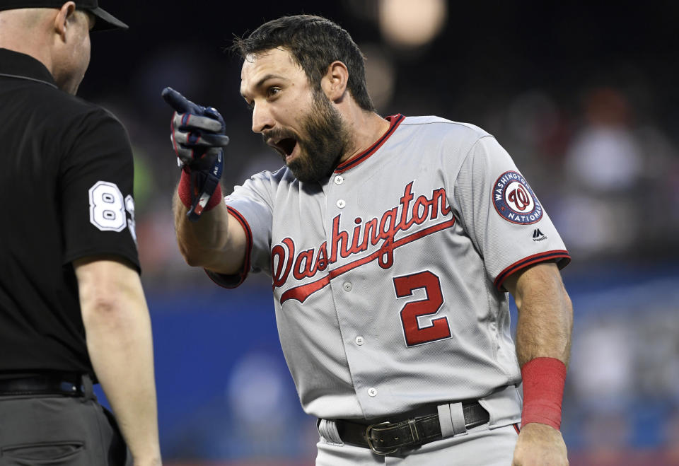 CORRECTS TO SAY EATON WAS SHOUTING TOWARD NEW YORK METS THIRD BASEMAN TODD FRAZIER - Washington Nationals' Adam Eaton, right, shouts toward New York Mets third baseman Todd Frazier after a double play was turned as first base umpire Mike Estabrook, left, stands by him in a baseball game Monday, May 20, 2019, in New York. (AP Photo/Sarah Stier)