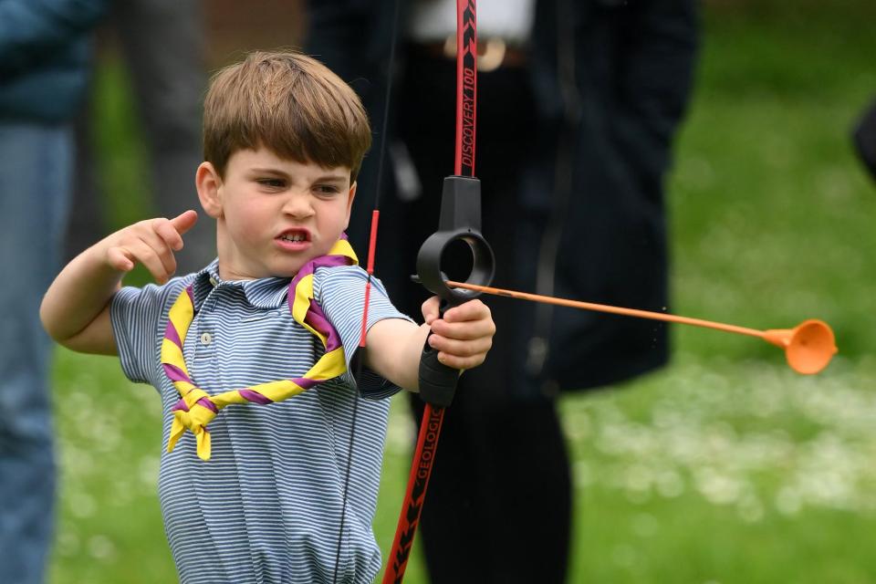 Britain's Prince Louis of Wales tries his hand at archery while taking part in the Big Help Out, during a visit to the 3rd Upton Scouts Hut in Slough, west of London on May 8, 2023, where the family joined volunteers helping to renovate and improve the building. - People across Britain were on Monday asked to do their duty as the celebrations for King Charles III's coronation drew to a close with a massive volunteering drive. (Photo by Daniel LEAL / POOL / AFP) (Photo by DANIEL LEAL/POOL/AFP via Getty Images)