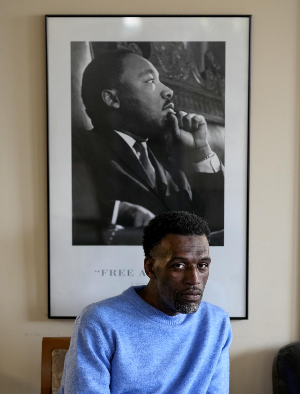 Brian Rodgers sits for a portrait in the common area of the St. Andrew's Court residence where he lives on Chicago's Westside Friday, Feb. 16, 2024, in Chicago. Rodgers, 50, struggled with homelessness for years after he was released from jail for a theft conviction. A Cook County judge rejected a ballot measure last week that would raise a one-time tax on luxury properties to fund services for homeless people in Chicago after objections from real estate and business groups. An appeal is pending as early voting begins. (AP Photo/Charles Rex Arbogast)