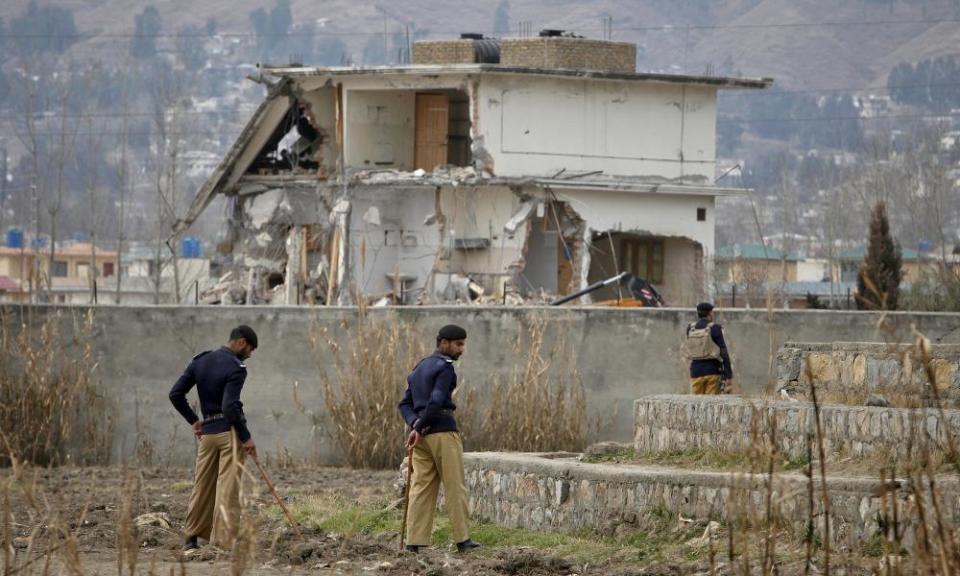 In 2012, policemen stand guard near the partially demolished compound where Osama bin Laden was killed.