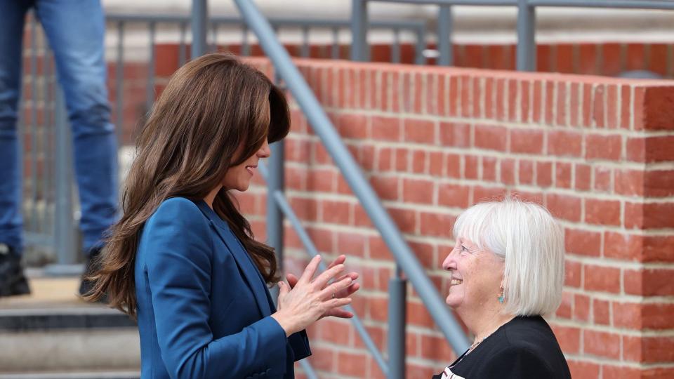 princess kate in teal suit talking to woman