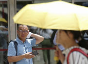 <p>A man wipes the sweat from his face in the scorching heat at a business district in Tokyo, July 23, 2018. (Photo: Koji Sasahara/AP) </p>