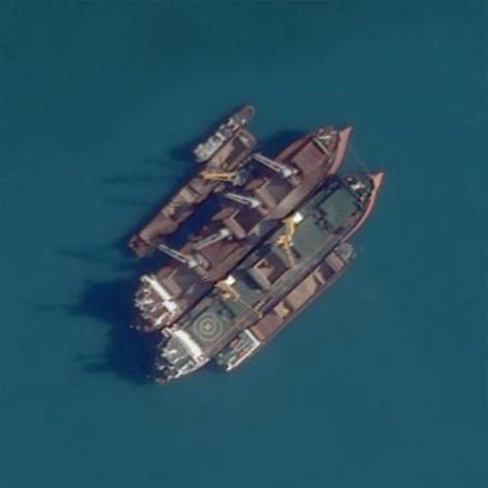 This Planet Labs satellite image shows a ship-to-ship transfer in the Kerch Strait, between Crimea and Russia, on Sept. 16, 2022. Satellite imagery and transponder data reviewed by The Associated Press shows numerous large cargo ships anchored off the Russian coast rendezvousing with smaller ships shuttling grain from both occupied Ukrainian ports in Crimea and Russian ports, obscuring the true origin of the cargo. Those larger ships then carried the blended grain to ports in Egypt, Libya, Iraq and Saudi Arabia. (Planet Labs via AP)