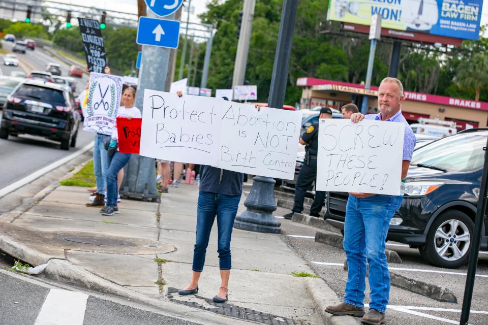 Angie, who refused to give her last name, left, and Brad Atkins were two of three anti-abortion protesters who rallied against abortion rights advocates at a Bans Off our Bodies Rally in Ocala on May 14. The Supreme Court overturned Roe v. Wade on Friday, eliminating a constitutional right to an abortion.