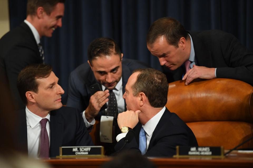 Daniel Goldman (L), attorney and director of investigations with the House Intelligence Committee, and House Intelligence Committee Chairman Adam Schiff (C) (D-CA) confer before William B. Taylor, Jr., the top American diplomat in Ukraine along with State Department Ukraine-Russia expert George Kent testify before the Permanent Select Committee on Intelligence in a public hearing in the impeachment inquiry into President Donald Trump, Nov. 13, 2019.