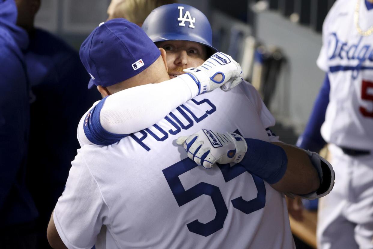 Dodgers third baseman Justin Turner hugs Albert Pujols after hitting a home run in the wild-card game on Oct. 6, 2021.