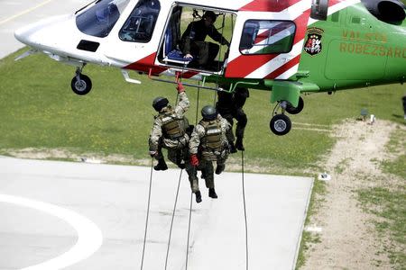 Latvia's border guards special task unit performs exercises as they prepare for patrolling over the EU external border with Russia in the airbase in Ludza, Latvia, in this May 2, 2014 file picture. REUTERS/Ints Kalnins/Files
